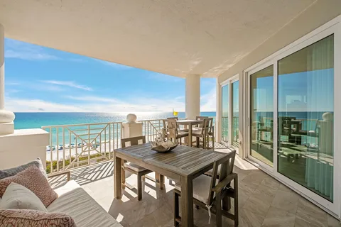 a view of table and couch in wooden floor