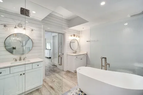 a bedroom with a bed and a flat tv screen on wall