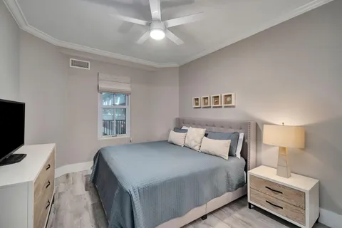 a bedroom with a bed and a chandelier