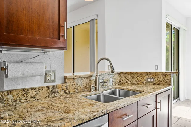 a kitchen with sink a refrigerator and cabinets