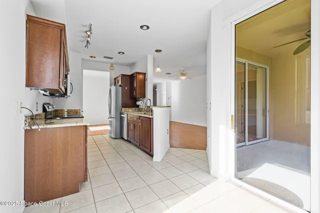 a kitchen with stainless steel appliances granite countertop a refrigerator and a stove