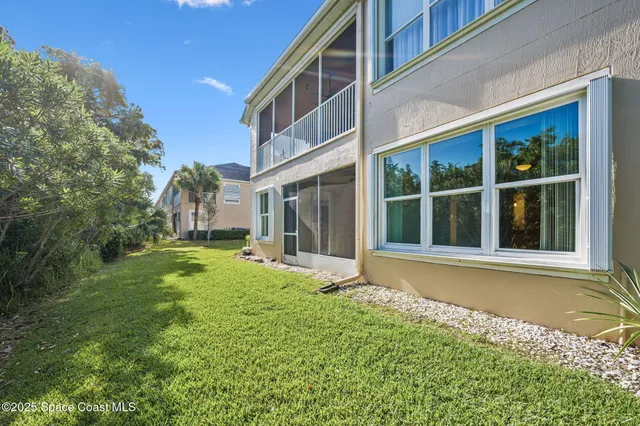 a view of a house with a yard and sitting area