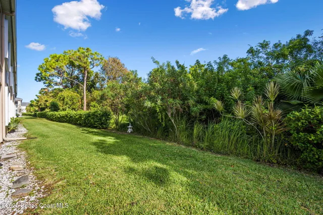 a view of a golf club with a backyard of a house