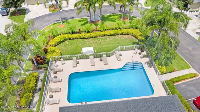an aerial view of a house with a swimming pool