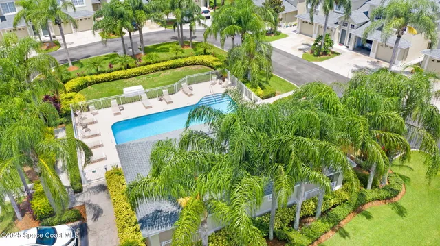 an aerial view of a house with a yard basket ball court