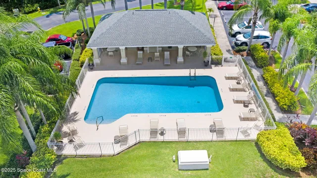 an aerial view of a house with swimming pool garden and patio