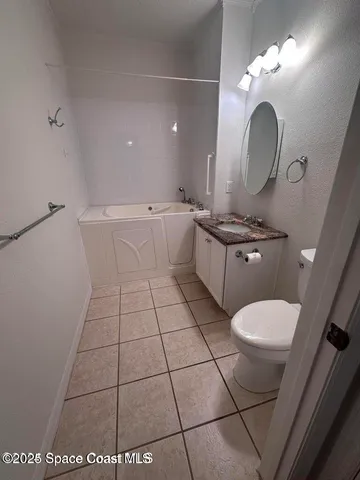 a bathroom with a sink mirror vanity and toilet
