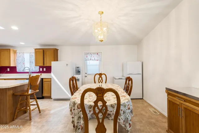 a living room with furniture a chandelier and a large window