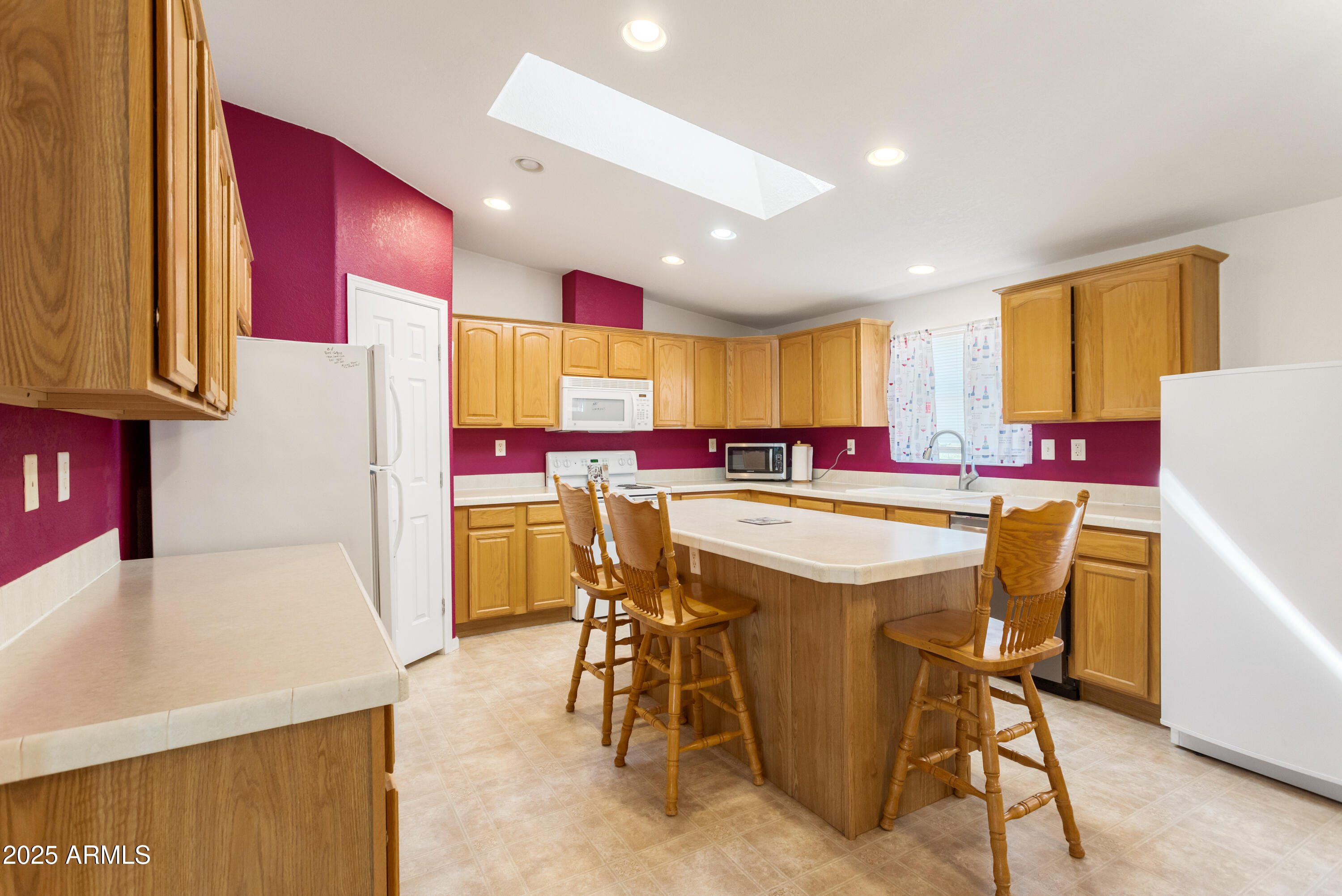 3526 West Rak Road Douglas, AZ 85607 - Photo 11 of 51 a kitchen with stainless steel appliances kitchen island granite countertop a table chairs and a refrigerator