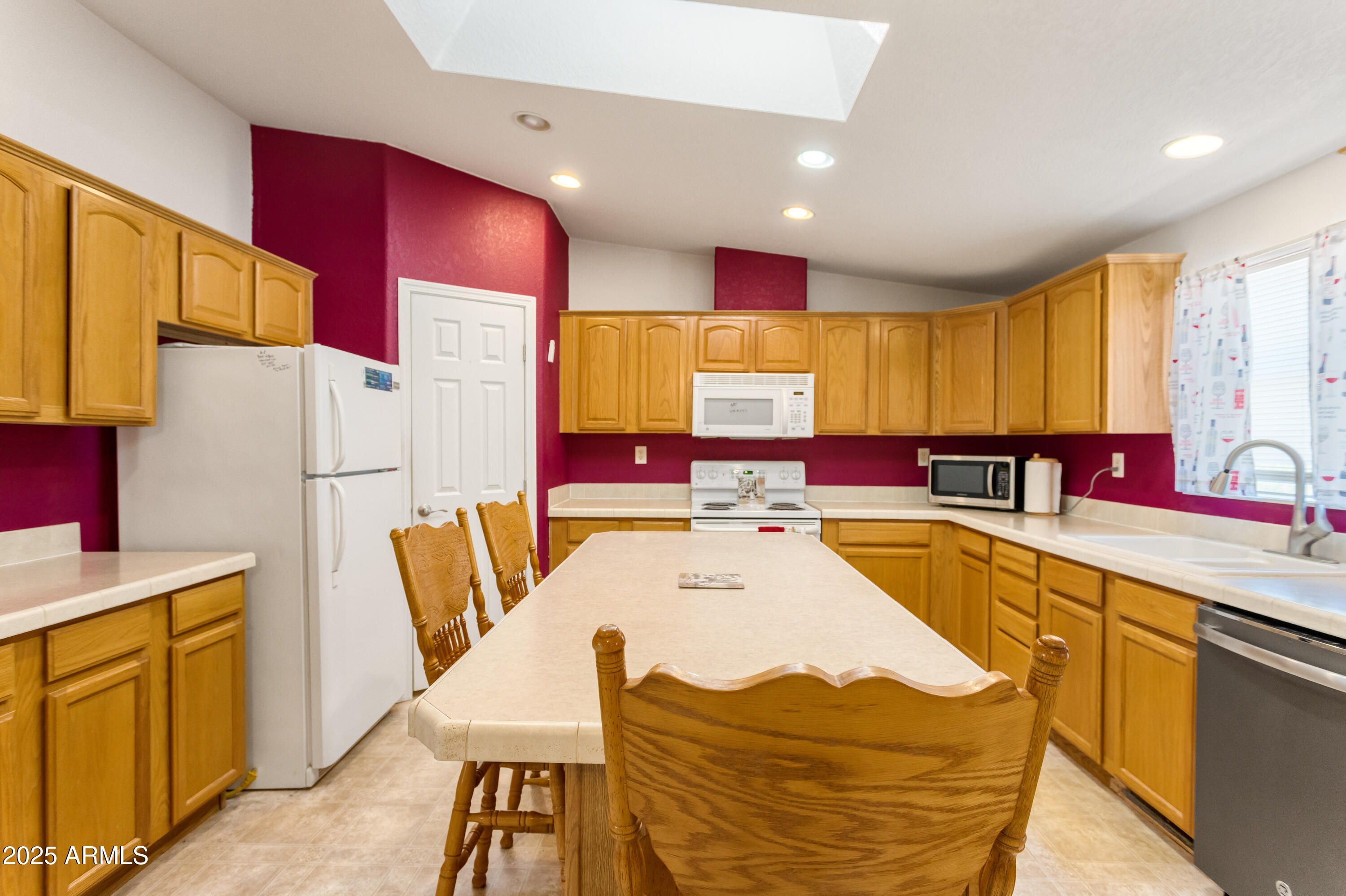 3526 West Rak Road Douglas, AZ 85607 - Photo 12 of 51 a kitchen with stainless steel appliances kitchen island granite countertop a refrigerator a stove a sink dishwasher with a dining table and chairs