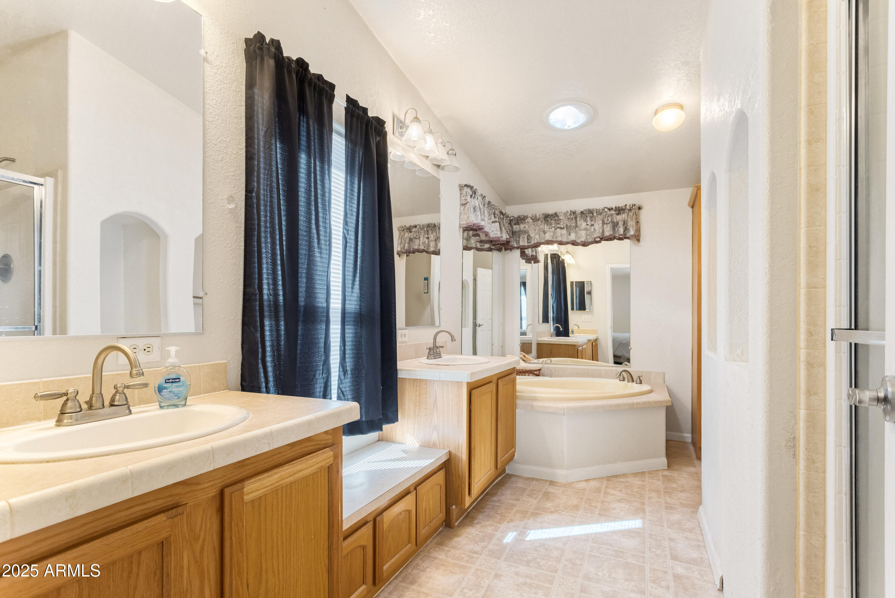 3526 West Rak Road Douglas, AZ 85607 - Photo 17 of 51 a large white kitchen with a sink and a large mirror