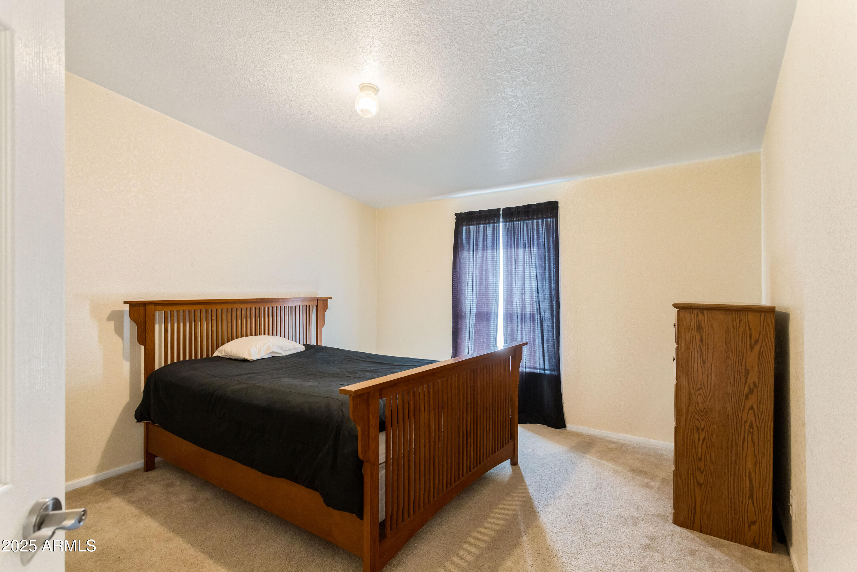 3526 West Rak Road Douglas, AZ 85607 - Photo 22 of 51 a bedroom with a bed and wooden floor
