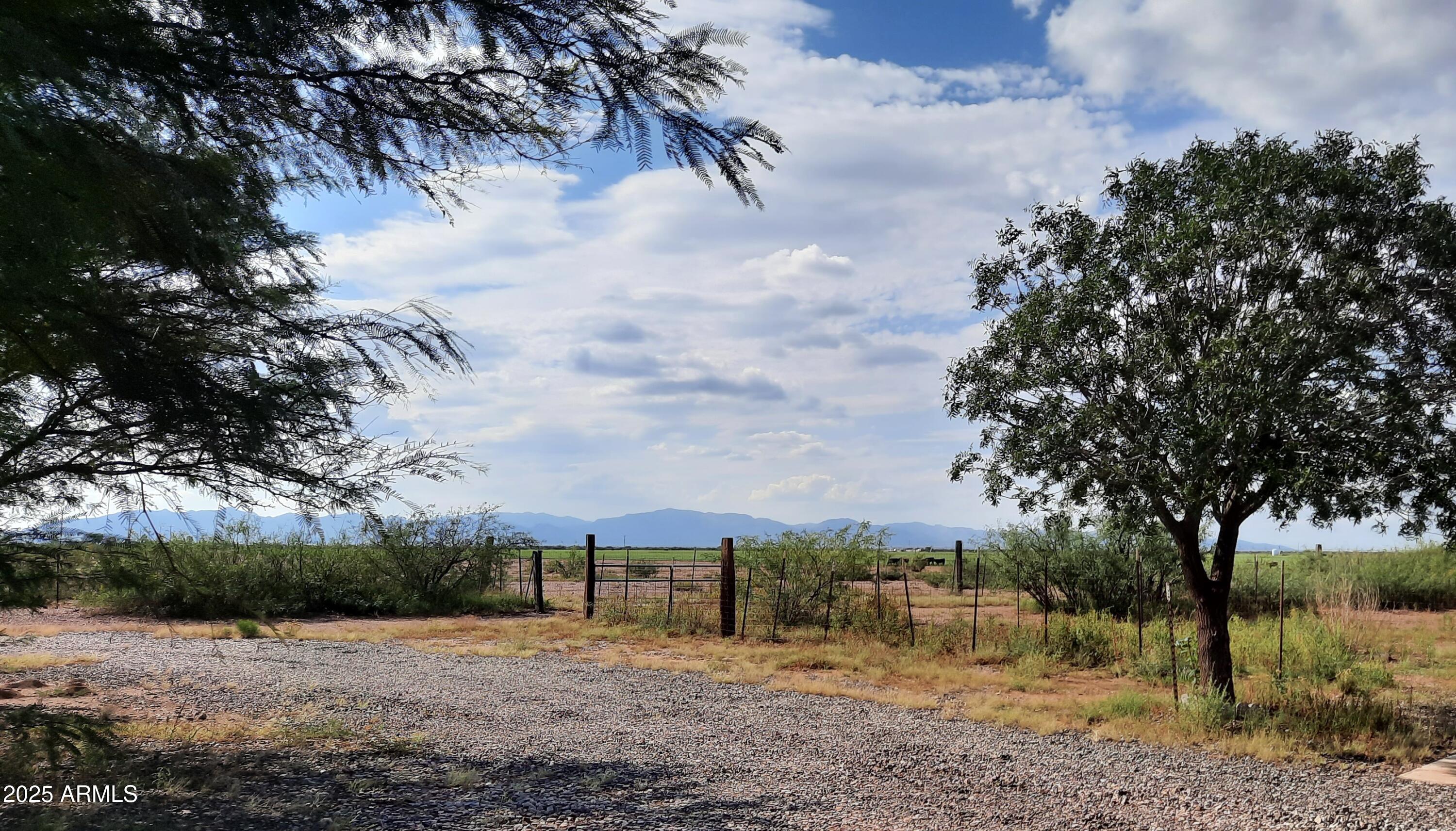 3526 West Rak Road Douglas, AZ 85607 - Photo 33 of 51 a view of a field with trees in the background