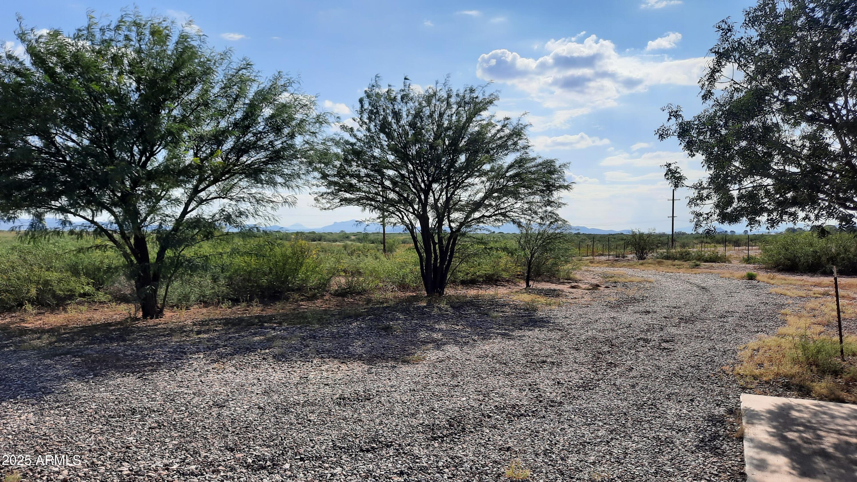 3526 West Rak Road Douglas, AZ 85607 - Photo 34 of 51 a view of a backyard with large trees