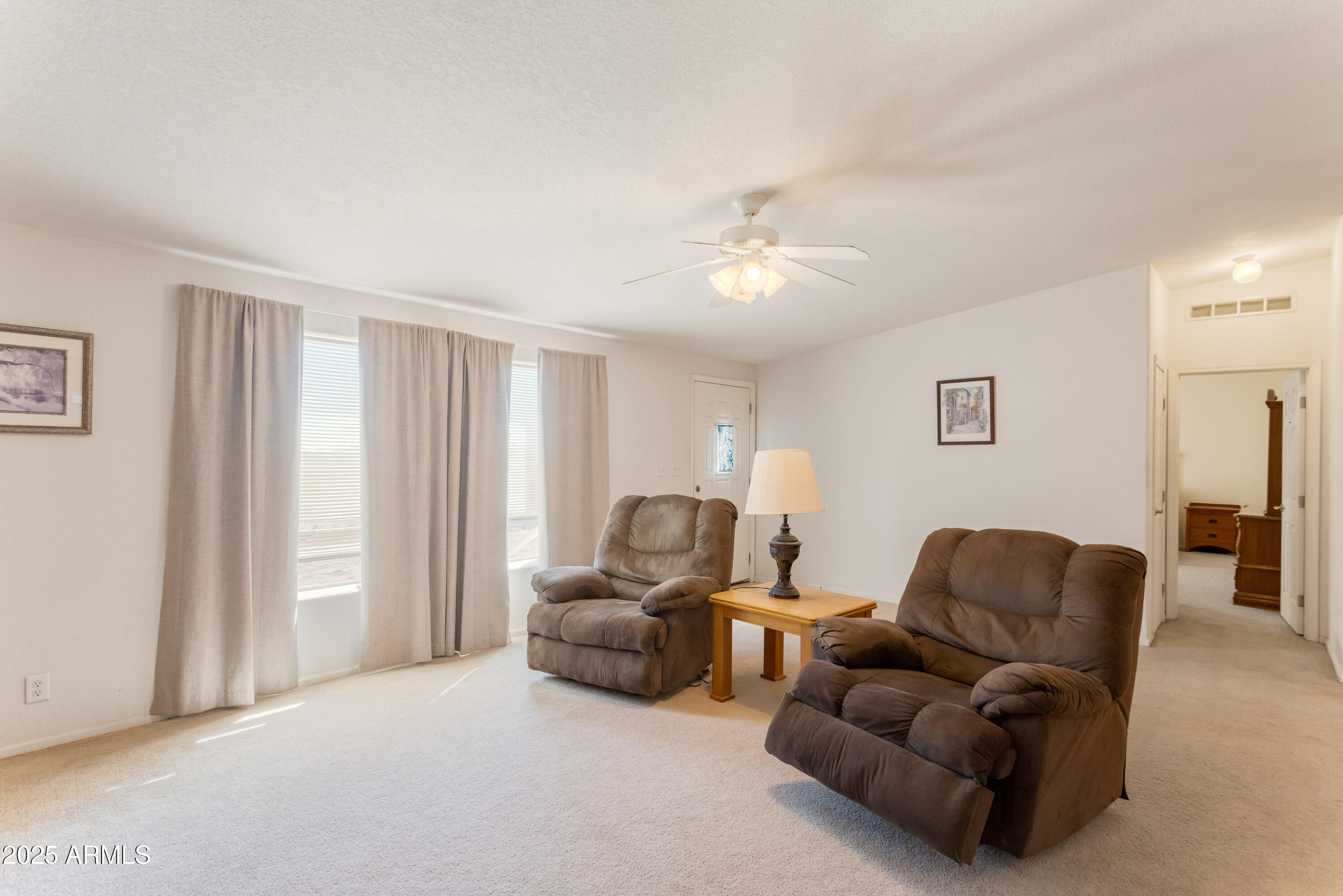 3526 West Rak Road Douglas, AZ 85607 - Photo 7 of 51 a living room with furniture and a chandelier