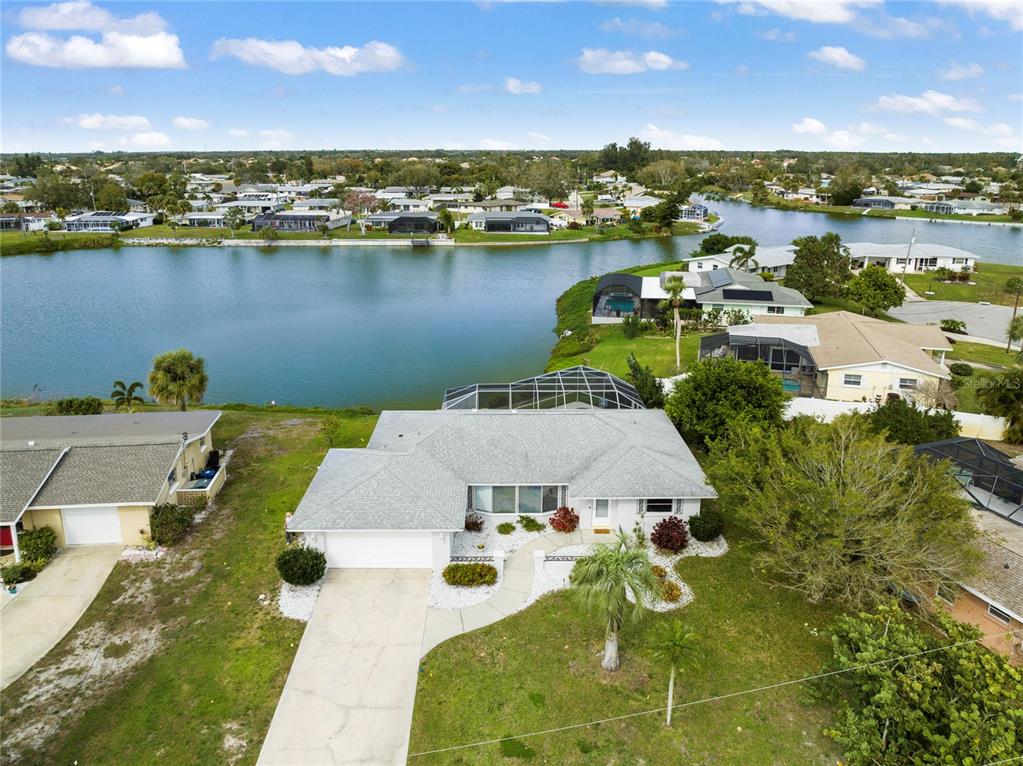 an aerial view of a house with a lake view