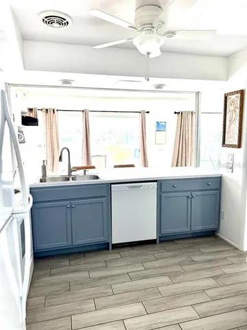 a kitchen with a sink cabinets and window