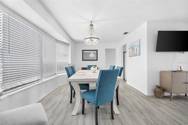 a view of a dining room with furniture window and wooden floor