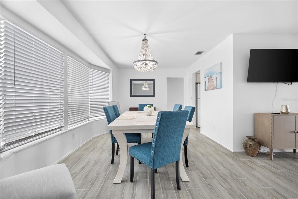 437 Hickory Road Venice, FL 34293 - Photo 16 of 33 a view of a dining room with furniture window and wooden floor