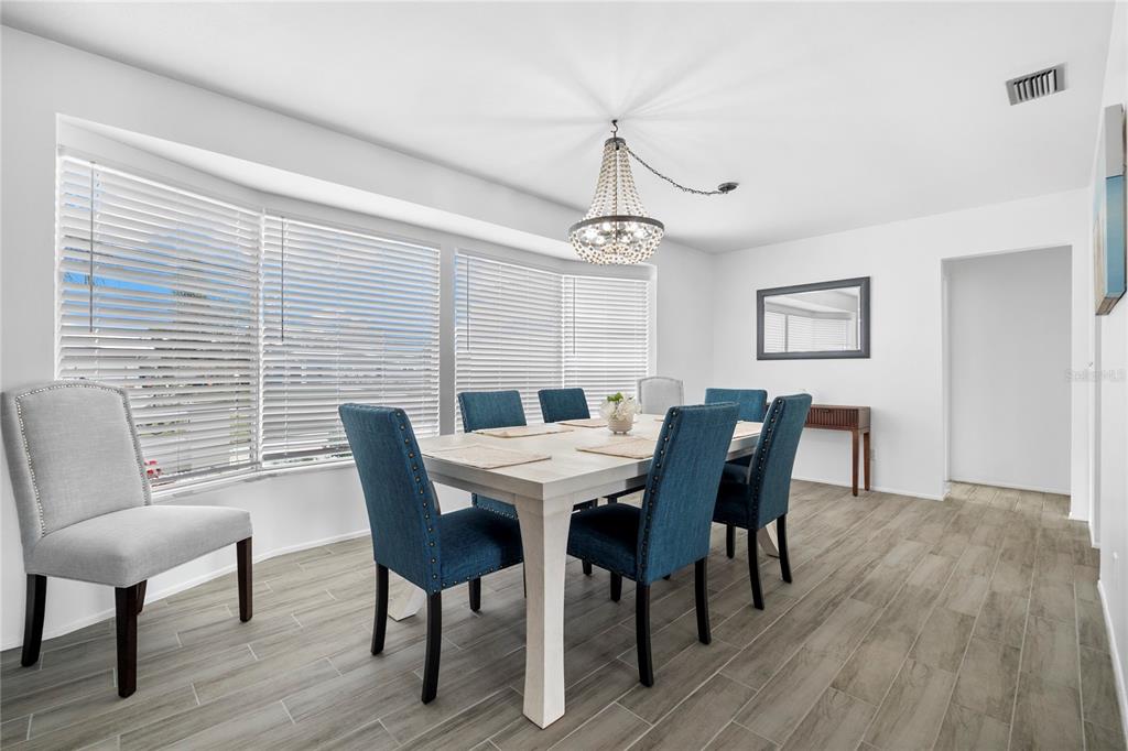 437 Hickory Road Venice, FL 34293 - Photo 17 of 33 a view of a dining room with furniture window and wooden floor