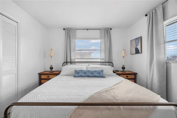 a bedroom with a bed and window