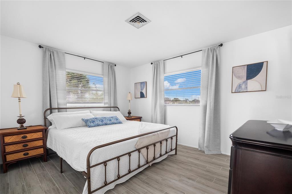 437 Hickory Road Venice, FL 34293 - Photo 20 of 33 a bedroom with a bed and wooden floor