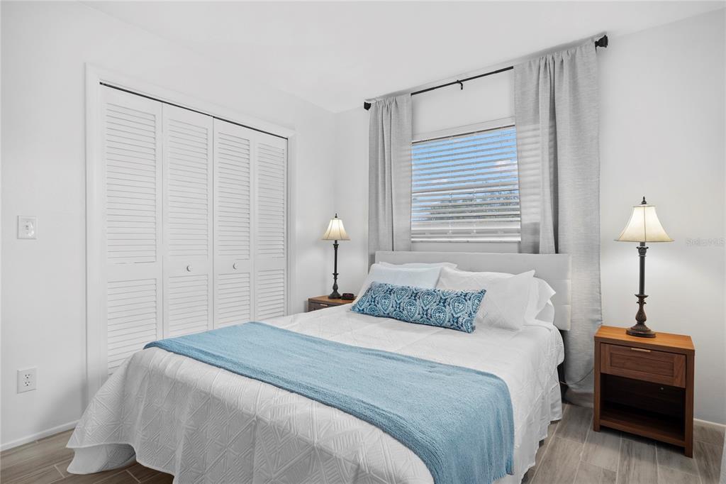 437 Hickory Road Venice, FL 34293 - Photo 21 of 33 a bedroom with a bed and a table