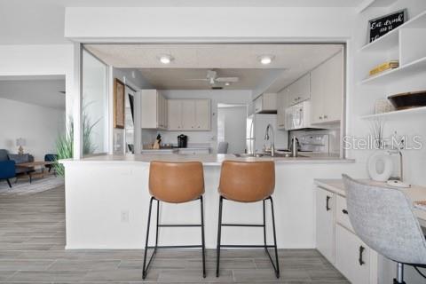 437 Hickory Road Venice, FL 34293 - Photo 29 of 33 a kitchen with stainless steel appliances granite countertop a table chairs sink and cabinets
