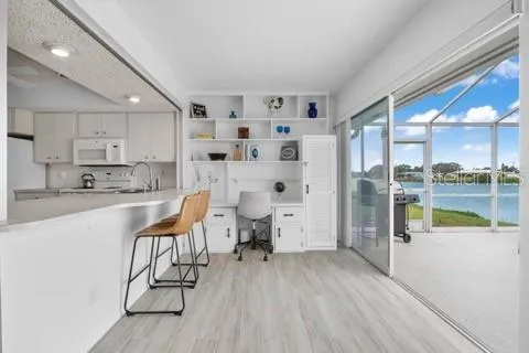 a kitchen with stainless steel appliances kitchen island granite countertop a refrigerator and a sink