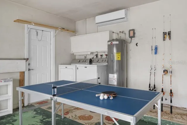a living room with stainless steel appliances furniture and rug