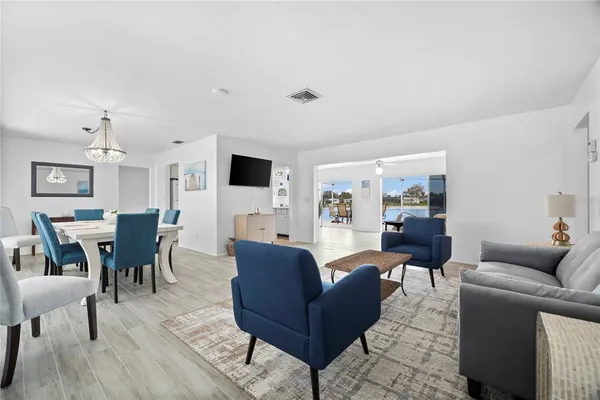 a living room with furniture wooden floor and a flat screen tv