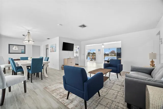 a living room with furniture wooden floor and a flat screen tv