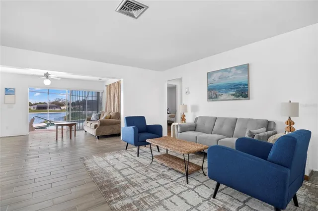 a living room with furniture and view of kitchen