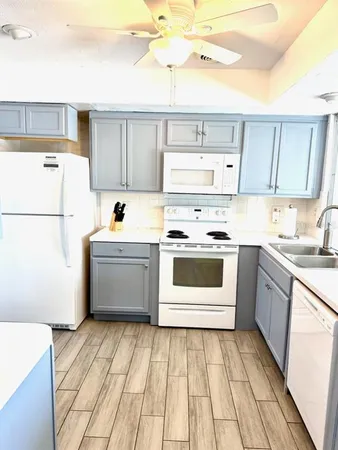 a kitchen with a white cabinets and white appliances