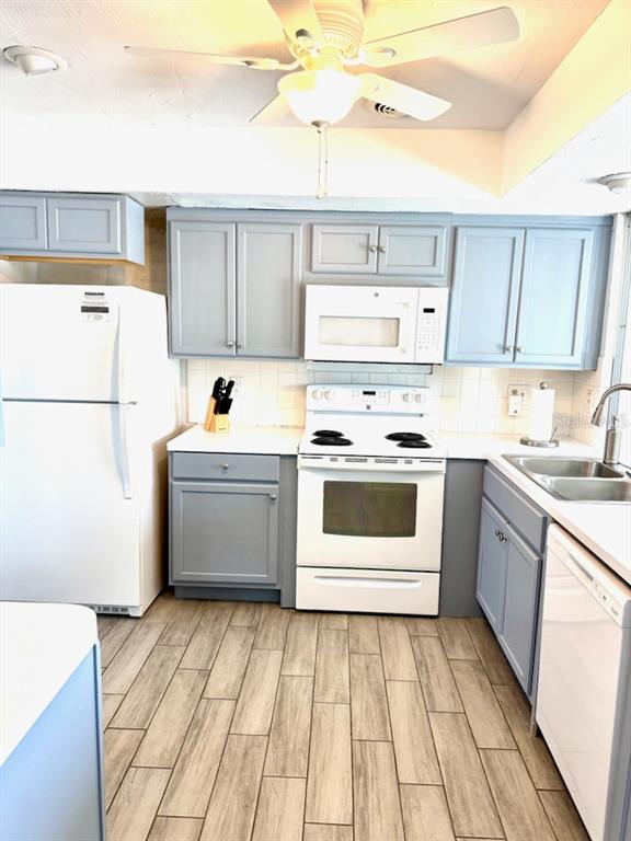 437 Hickory Road Venice, FL 34293 - Photo 10 of 33 a kitchen with a white cabinets and white appliances