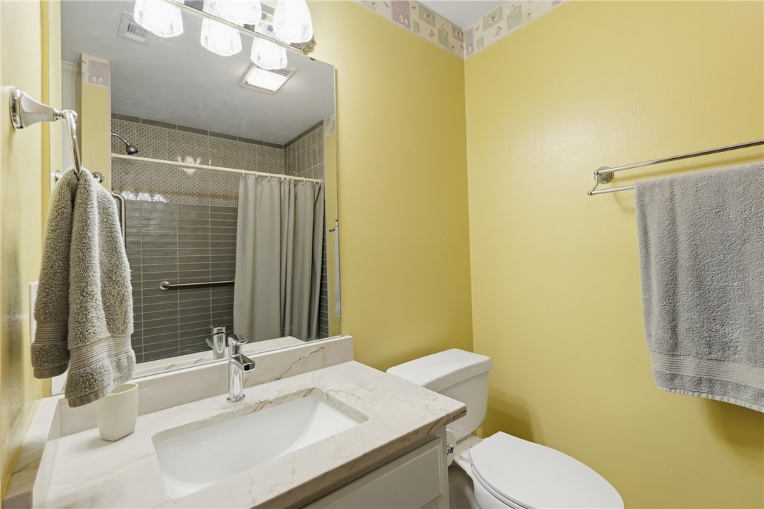 1520 Bennett Street Bryan, TX 77802 - Photo 18 of 24 a bathroom with a sink a toilet and shower