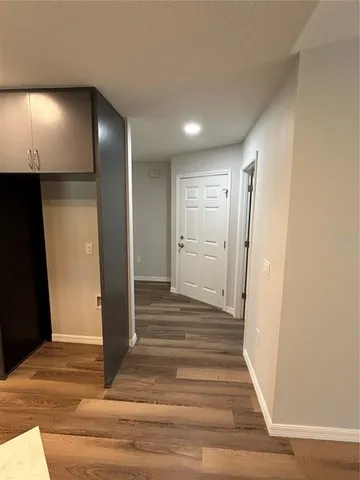 a view of a hallway with wooden floor