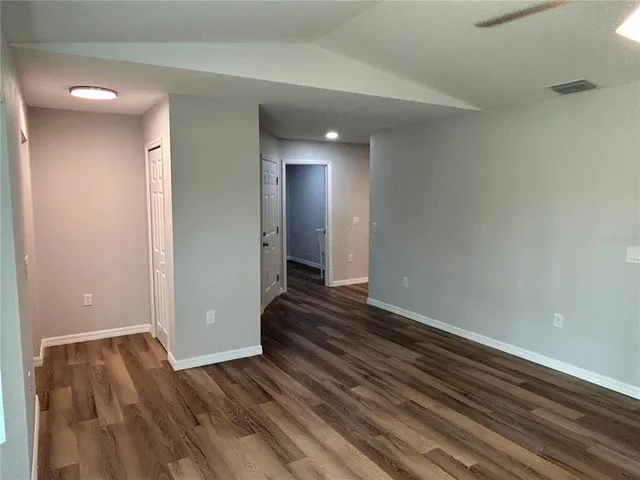 a view of a room with wooden floor