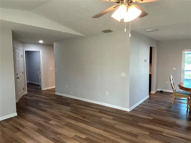 a view of an empty room and wooden floor