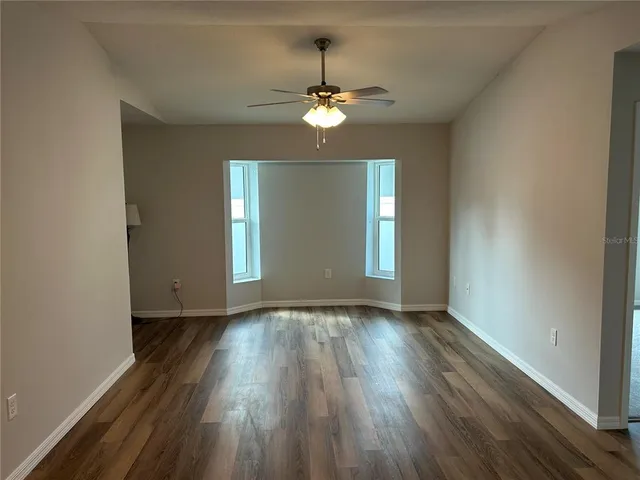 a view of a hallway with wooden floor and entryway