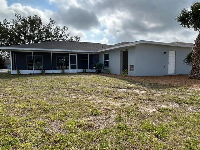 a view of a house with a garden and pathway