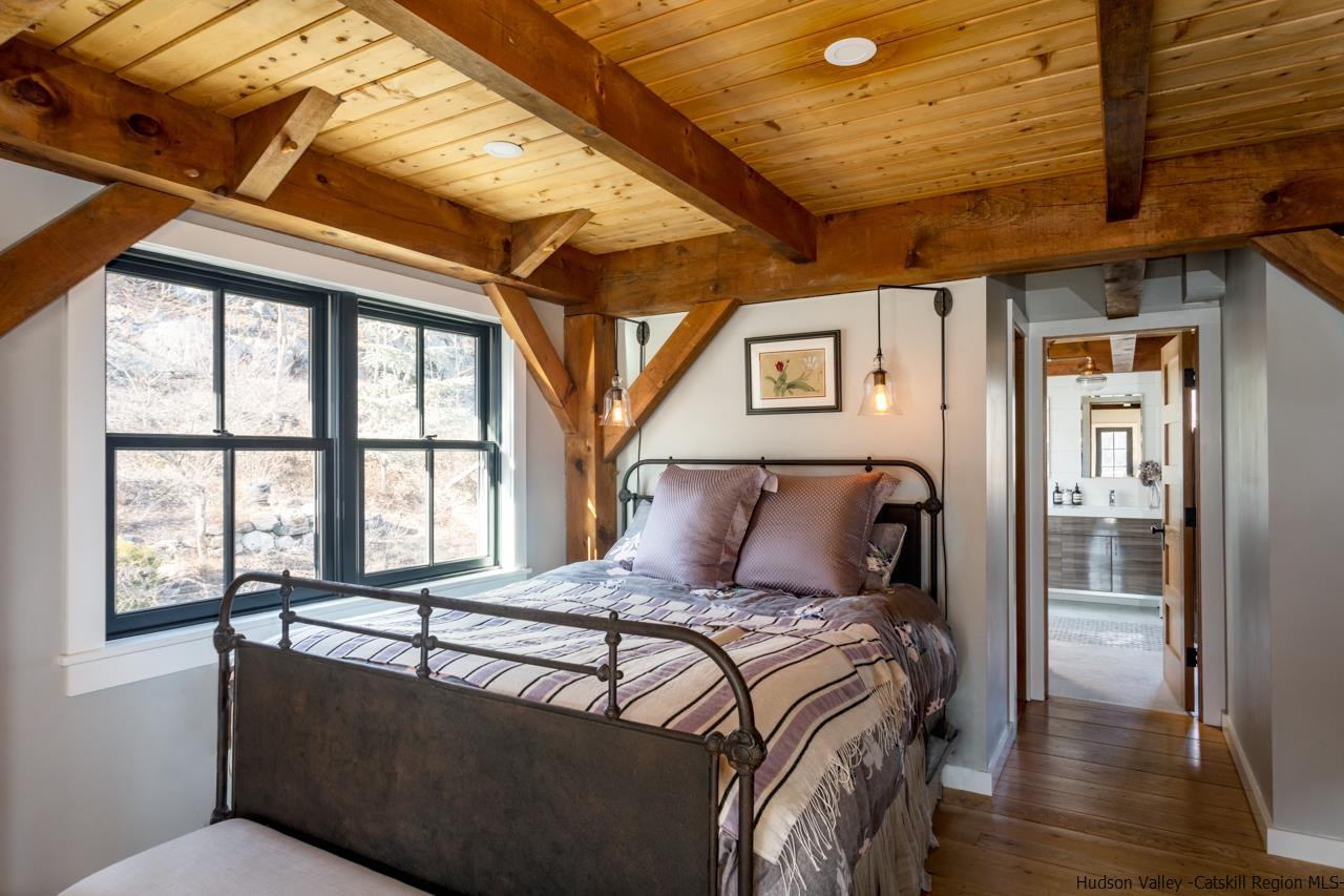 21 Red Oak Lane Garrison, NY 10524 - Photo 20 of 35 a bed sitting in a bedroom next to a window