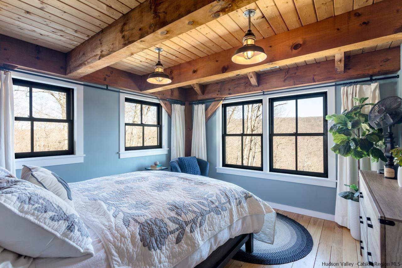 21 Red Oak Lane Garrison, NY 10524 - Photo 22 of 35 a spacious bedroom with a large bed and a large window