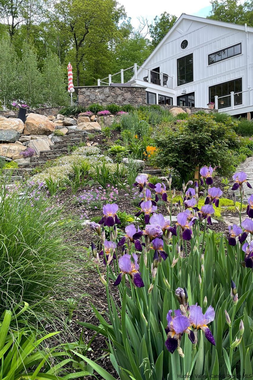 21 Red Oak Lane Garrison, NY 10524 - Photo 24 of 35 a front view of house with yard and flowers around