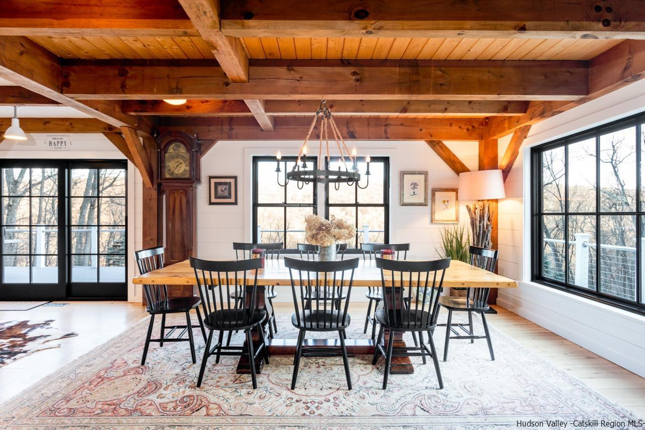 21 Red Oak Lane Garrison, NY 10524 - Photo 9 of 35 a view of a dining room with furniture large windows and wooden floor
