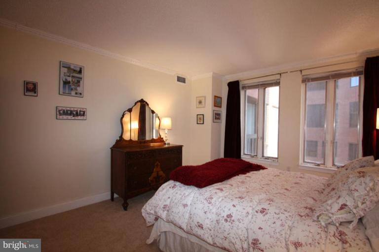 1045 31st Street Northwest, Unit 202 Washington, DC 20007 - Photo 12 of 21 a bedroom with a bed window and dresser