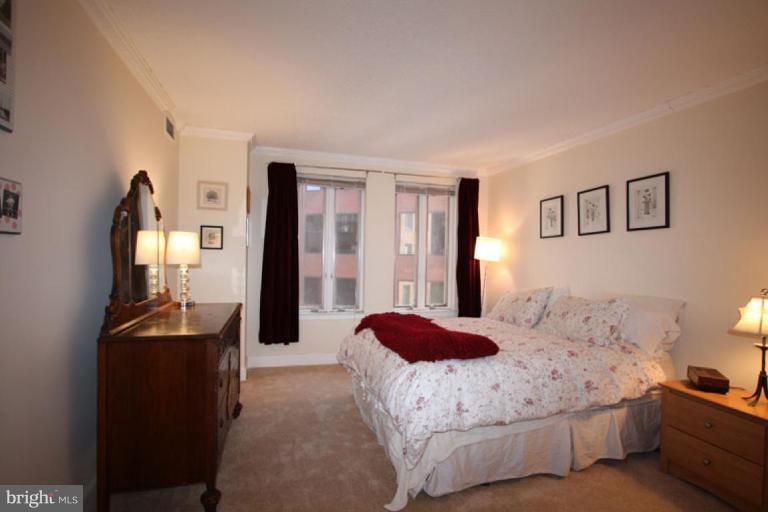 1045 31st Street Northwest, Unit 202 Washington, DC 20007 - Photo 20 of 21 a bedroom with a bed and a dresser