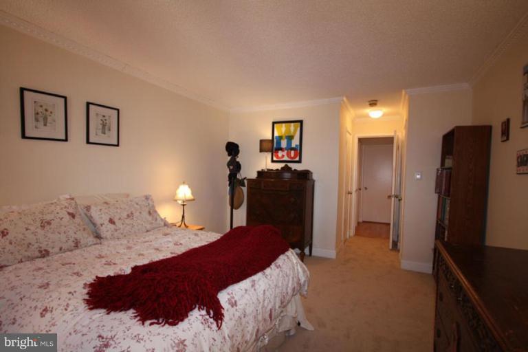 1045 31st Street Northwest, Unit 202 Washington, DC 20007 - Photo 21 of 21 a bedroom with a bed and dresser