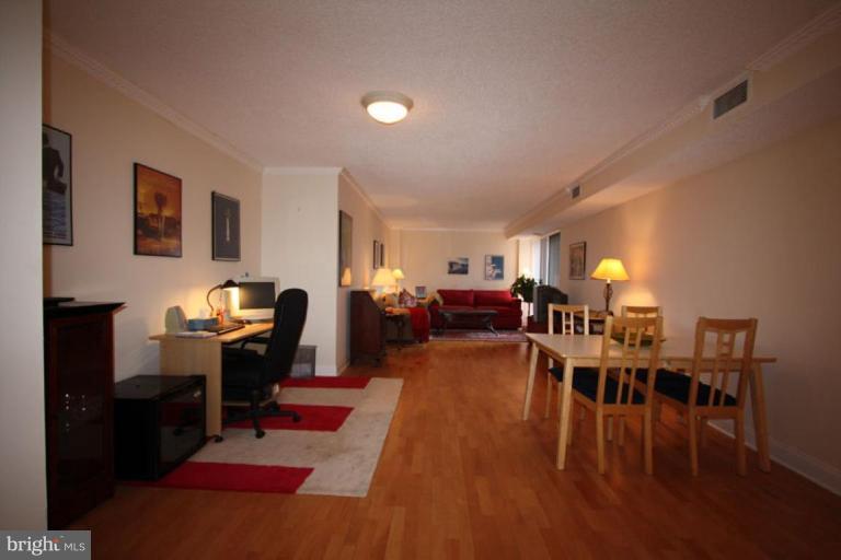 1045 31st Street Northwest, Unit 202 Washington, DC 20007 - Photo 5 of 21 a living room with furniture dining table and wooden floor