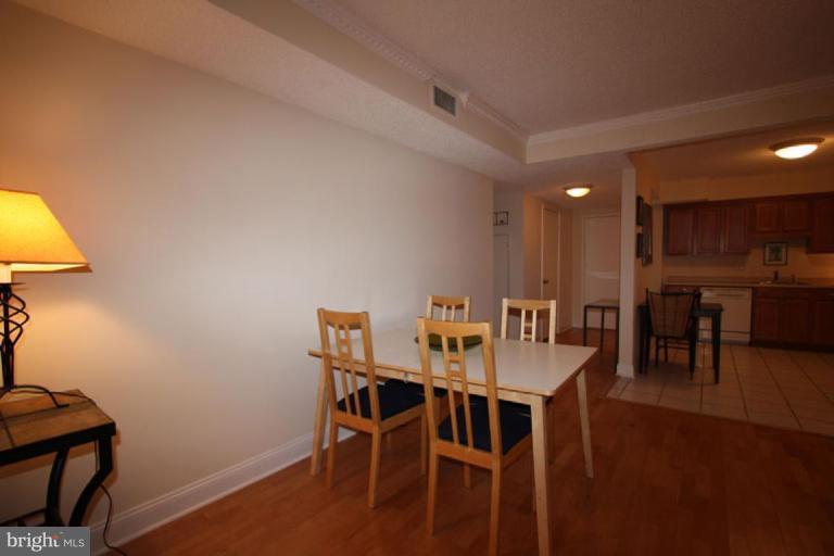 1045 31st Street Northwest, Unit 202 Washington, DC 20007 - Photo 9 of 21 a view of a dining room with furniture and wooden floor